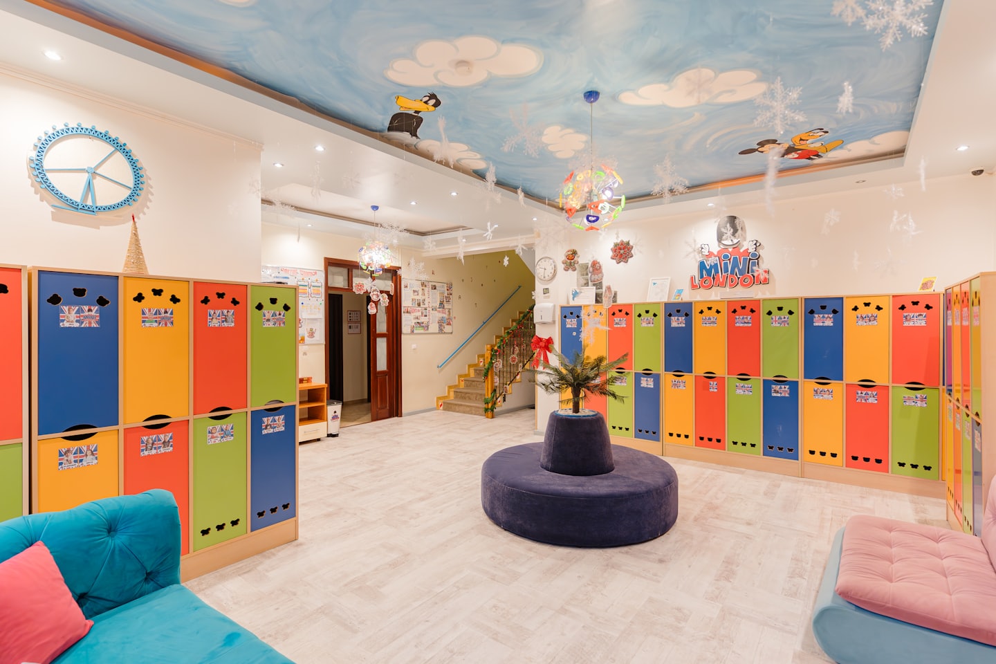 Multi-colored lockers line a playful daycare entrance with a circular bench.